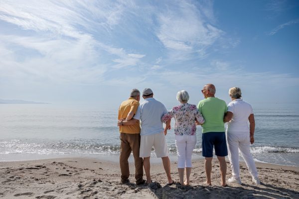 Group,Of,5,Seniors,At,The,Beach,Standing,Together,Looking